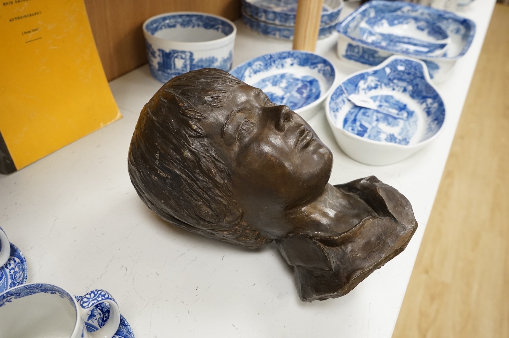 A bronzed head of a child, unsigned, 33cm high